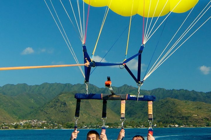 a person flying through the air over a body of water